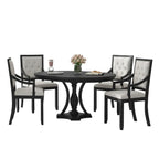 black and oak round dining table set with four matching chairs arranged in dining room interior