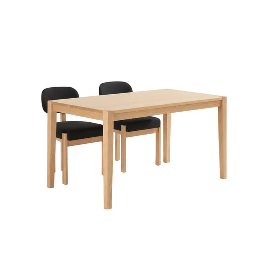 black upholstered dining chair set with rubber wood legs arranged beside dining table indoors