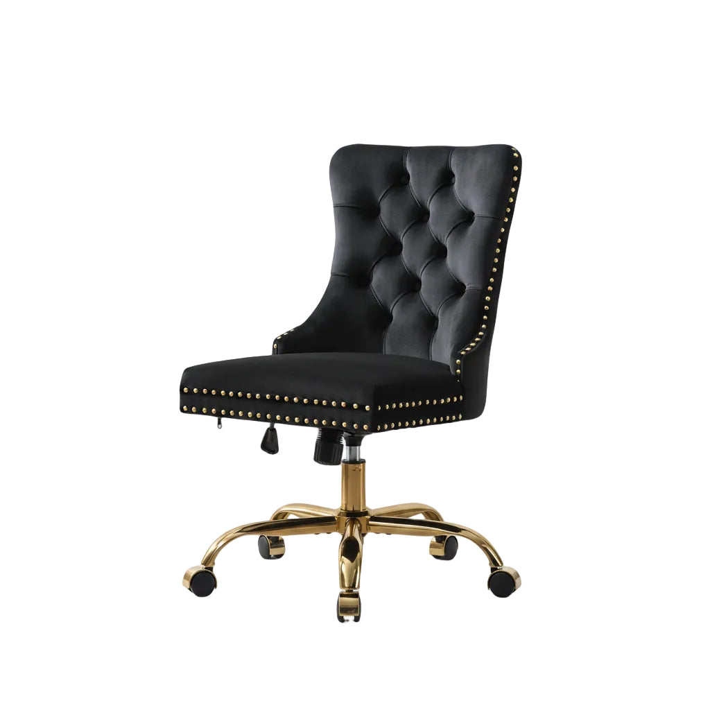 black velvet tufted desk chair with gold tone metal base shown from front angle beside workspace desk