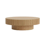 natural ash oval drum coffee table with pedestal base placed in modern living room interior