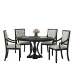 round dining room table with black support structure and oak finish tabletop surface
